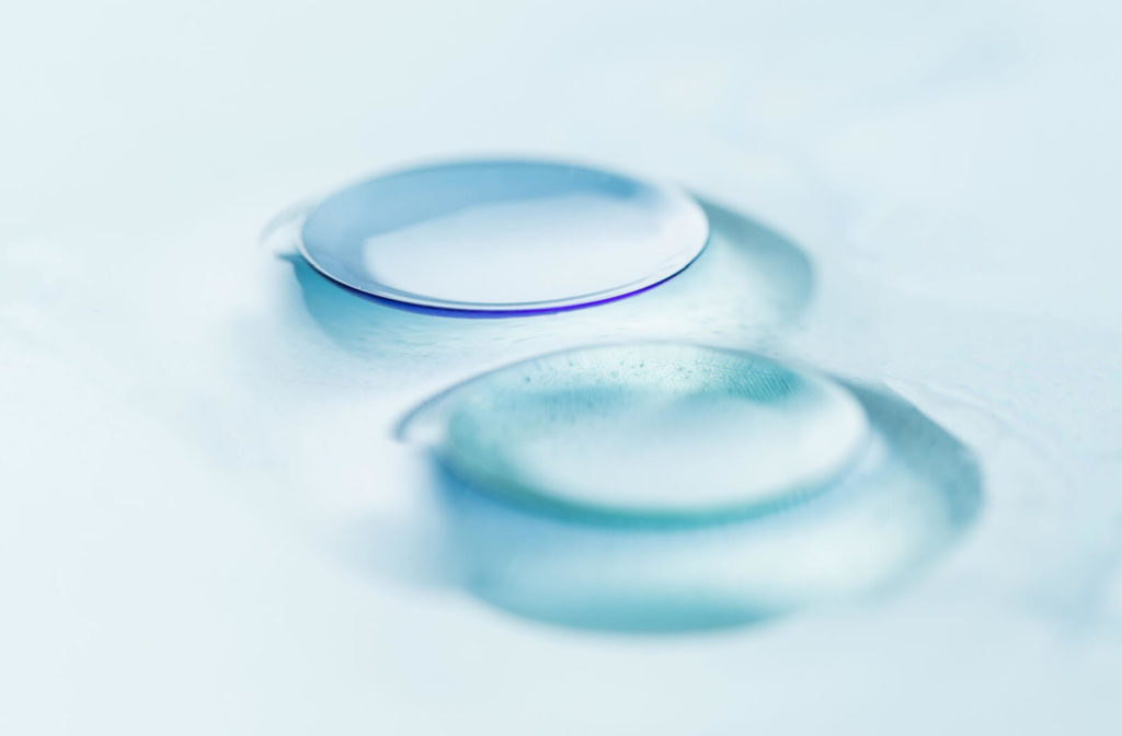 A close-up of modern rigid gas permeable contact lenses for astigmatism.