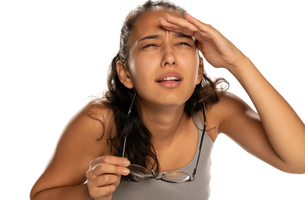 A young woman removed her eye glasses and squinted to get clearer vision.