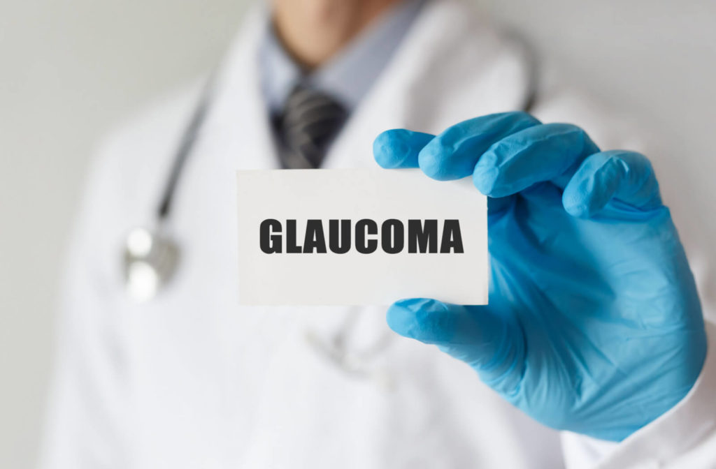 A male doctor holding a card with text GLAUCOMA.