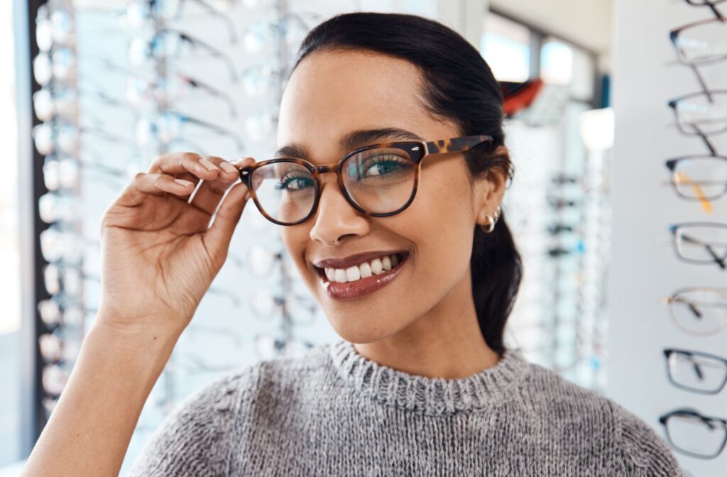 A person trying on a new pair of glasses at their optometrist's office.