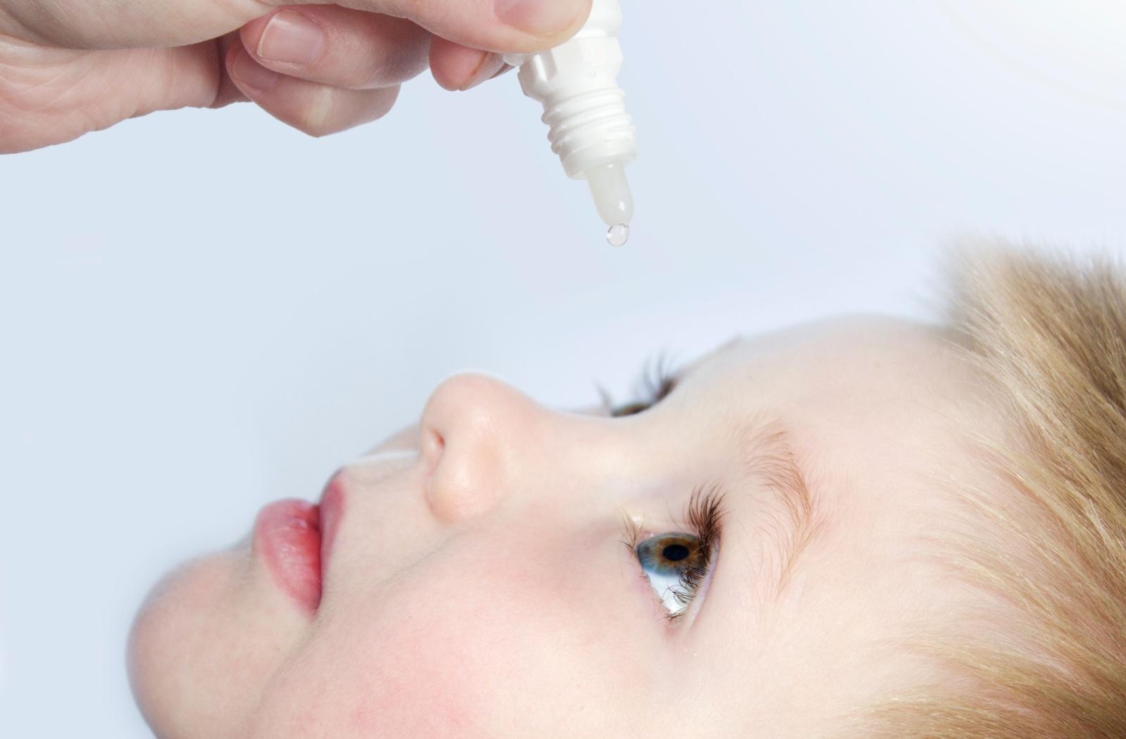 A child using atropine eye drops to help slow the progression of myopia.